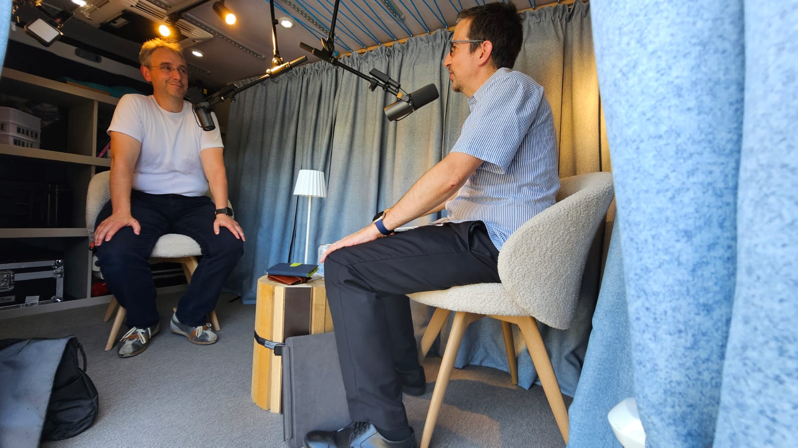 Two people in conversation during podcast recording